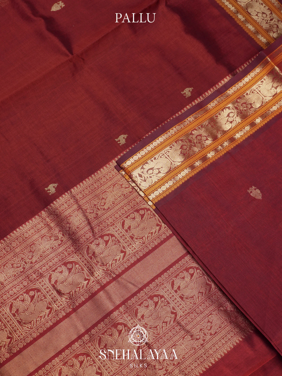 Maroon Kanchi Silk Cotton Saree with Burnt Orange and Antique Gold Peacock Border