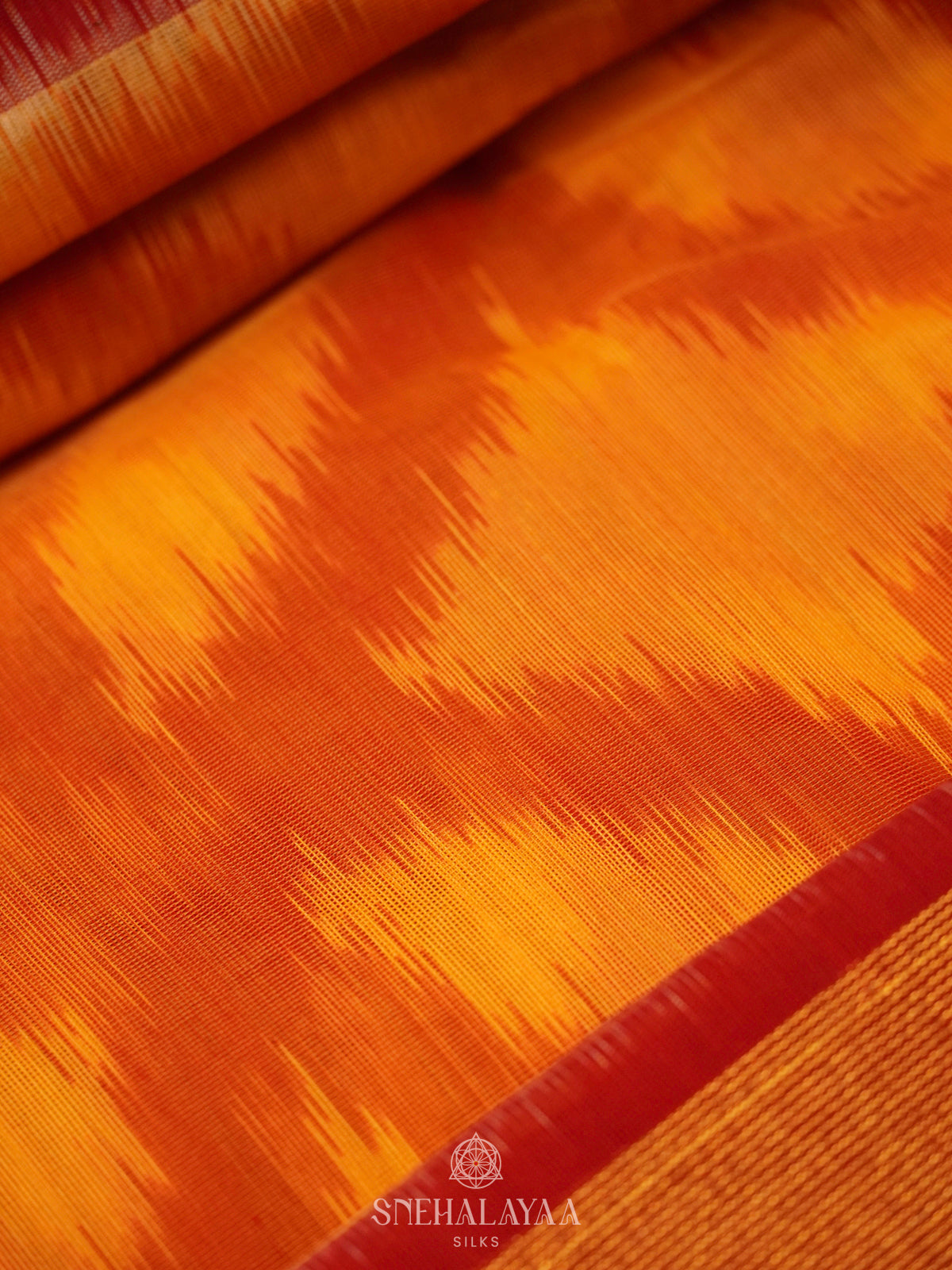 Sunset Orange Ikat Silk Cotton Saree with Traditional Woven Border
